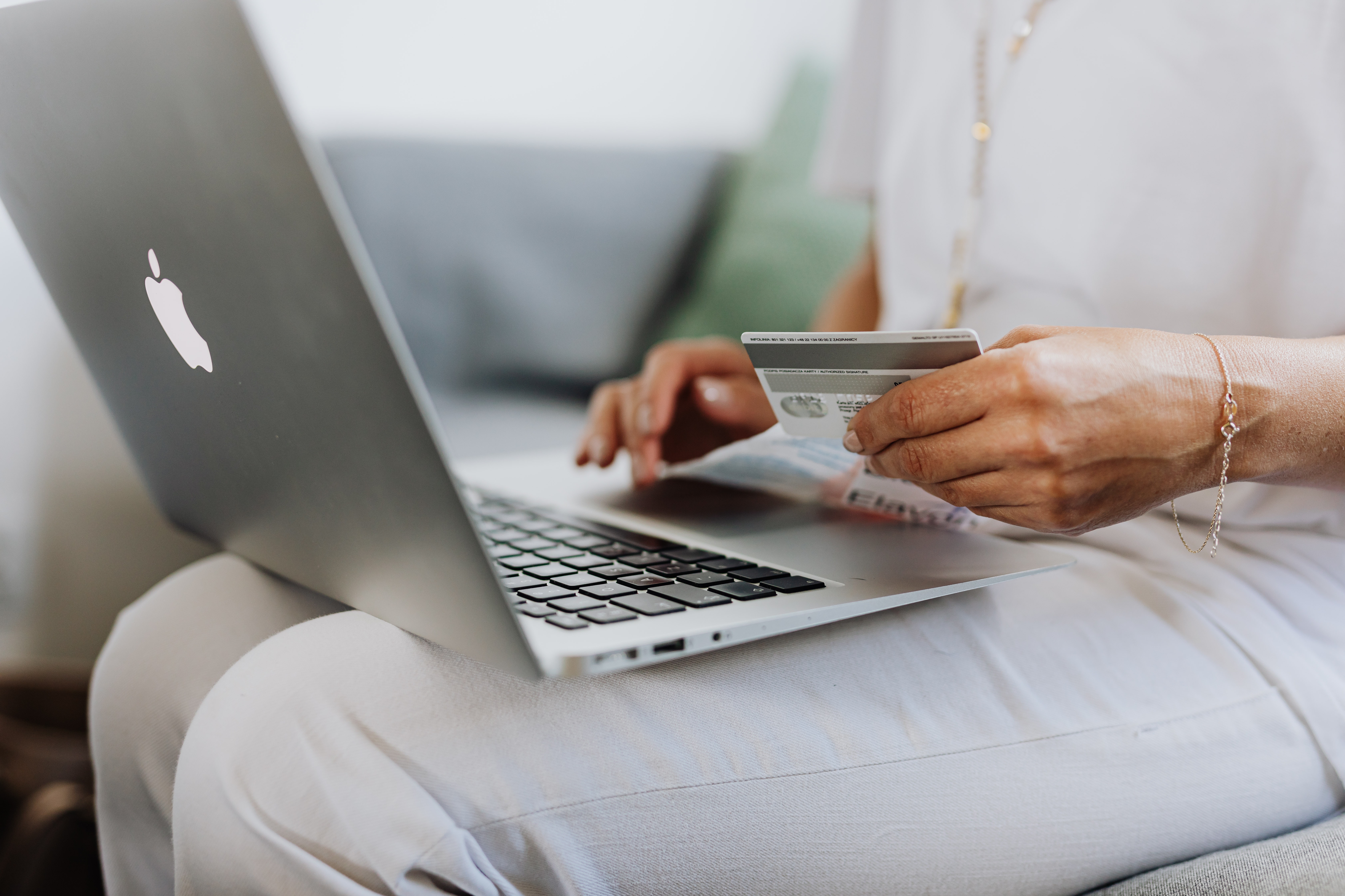 Women holding credit card and laptop